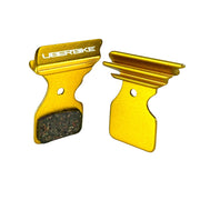 gold finned Shimano 105 R7020 disc brake pads on a white background