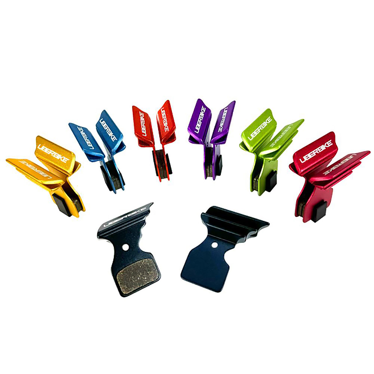 Various coloured finned Shimano 105 R7020 disc brake pads on a white background