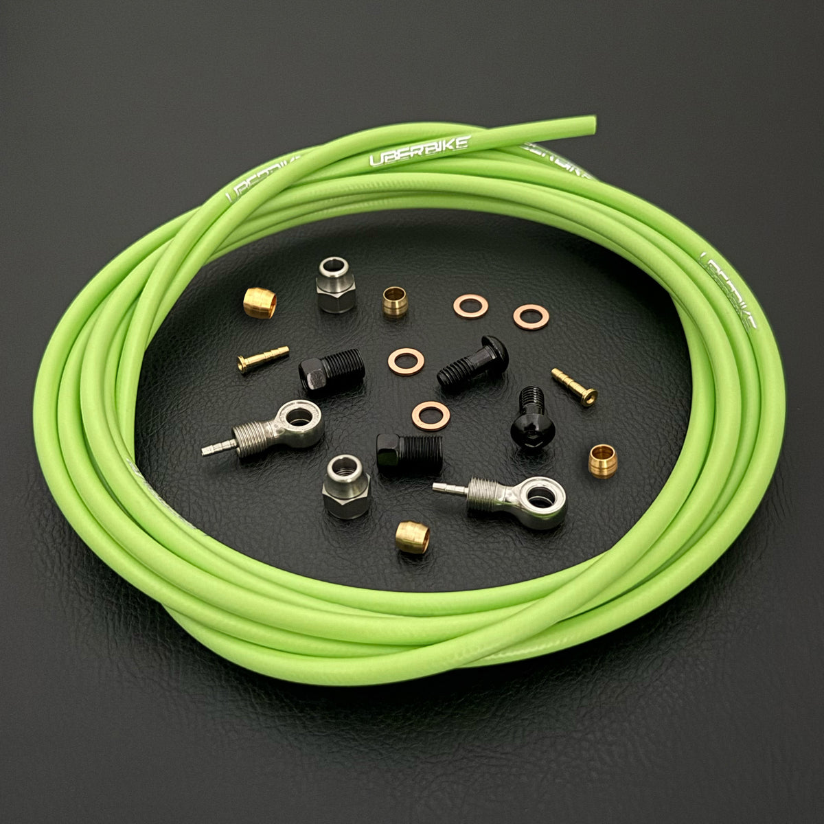 Shimano deore xt hydraulic green kevlar brake hose kit with banjo fittings and Uberbike branding on a black background