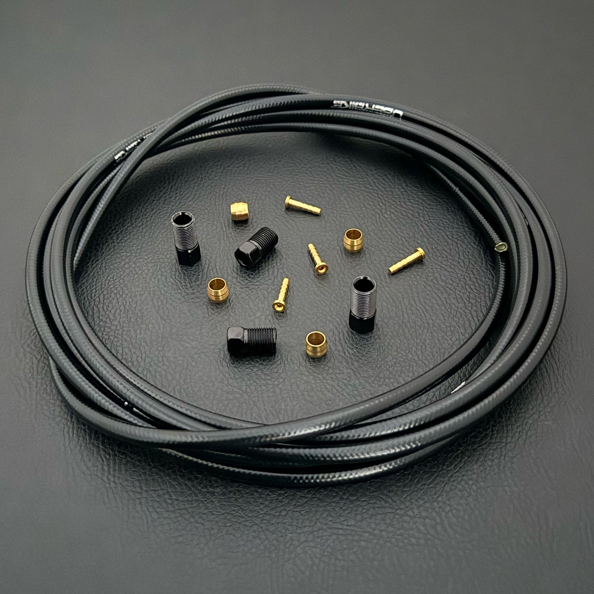 Shimano deore hydraulic black kevlar brake hose kit with straight connector fittings and Uberbike branding on a black background
