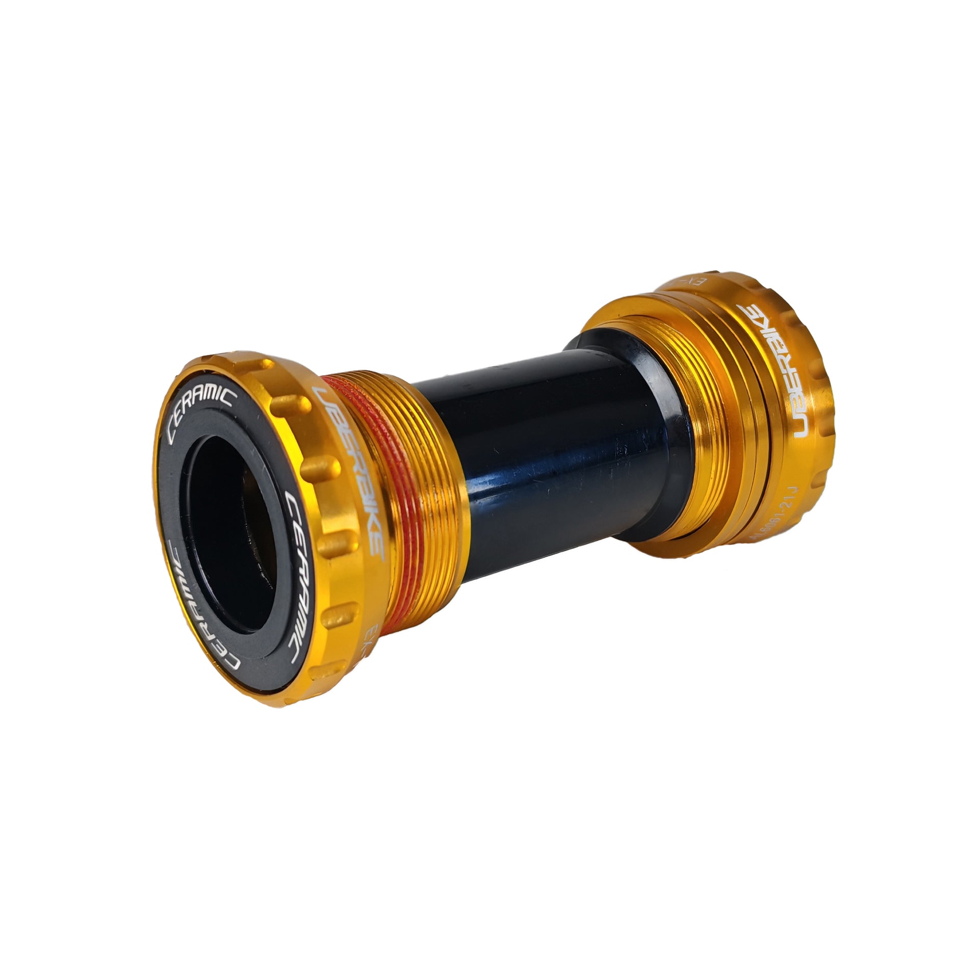 Gold Shimano Hollowtech II ceramic bottom bracket with uberbike branding on a white background