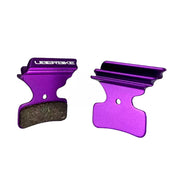 Purple finned Shimano M8120 disc brake pads on a white background
