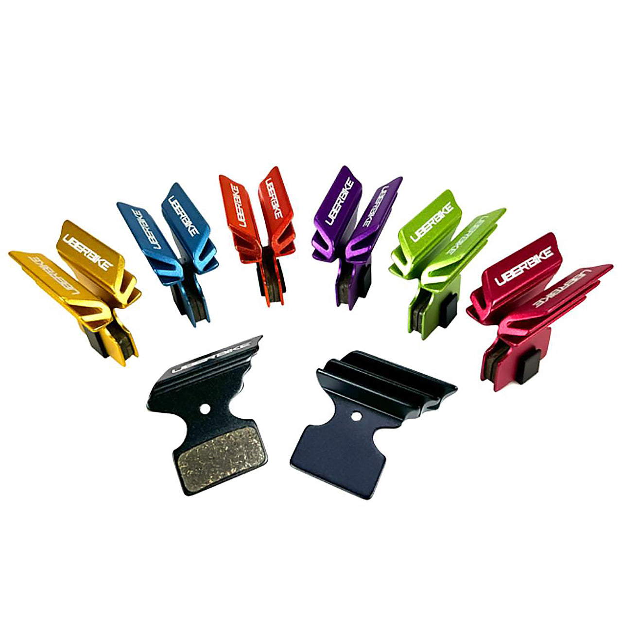Various coloured finned Shimano M985 brake pads on a white background