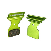 green finned Shimano R9120 disc brake pads on a white background