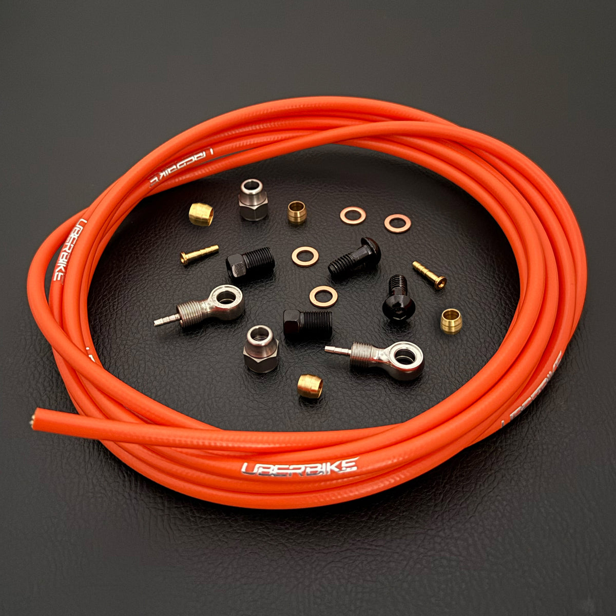 Shimano slx ORANGE  kevlar hydraulic brake hose kit with banjo fittings and Uberbike branding on a black background