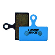 Shimano SLX M7100 brake pads on a white background. 