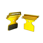 gold finned Shimano XT M8100 disc brake pads on a white background