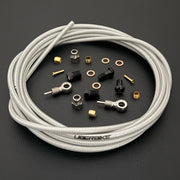 Shimano XTRraw silver braid kevlar hydraulic brake hose kit with banjo fittings and Uberbike branding on a black background