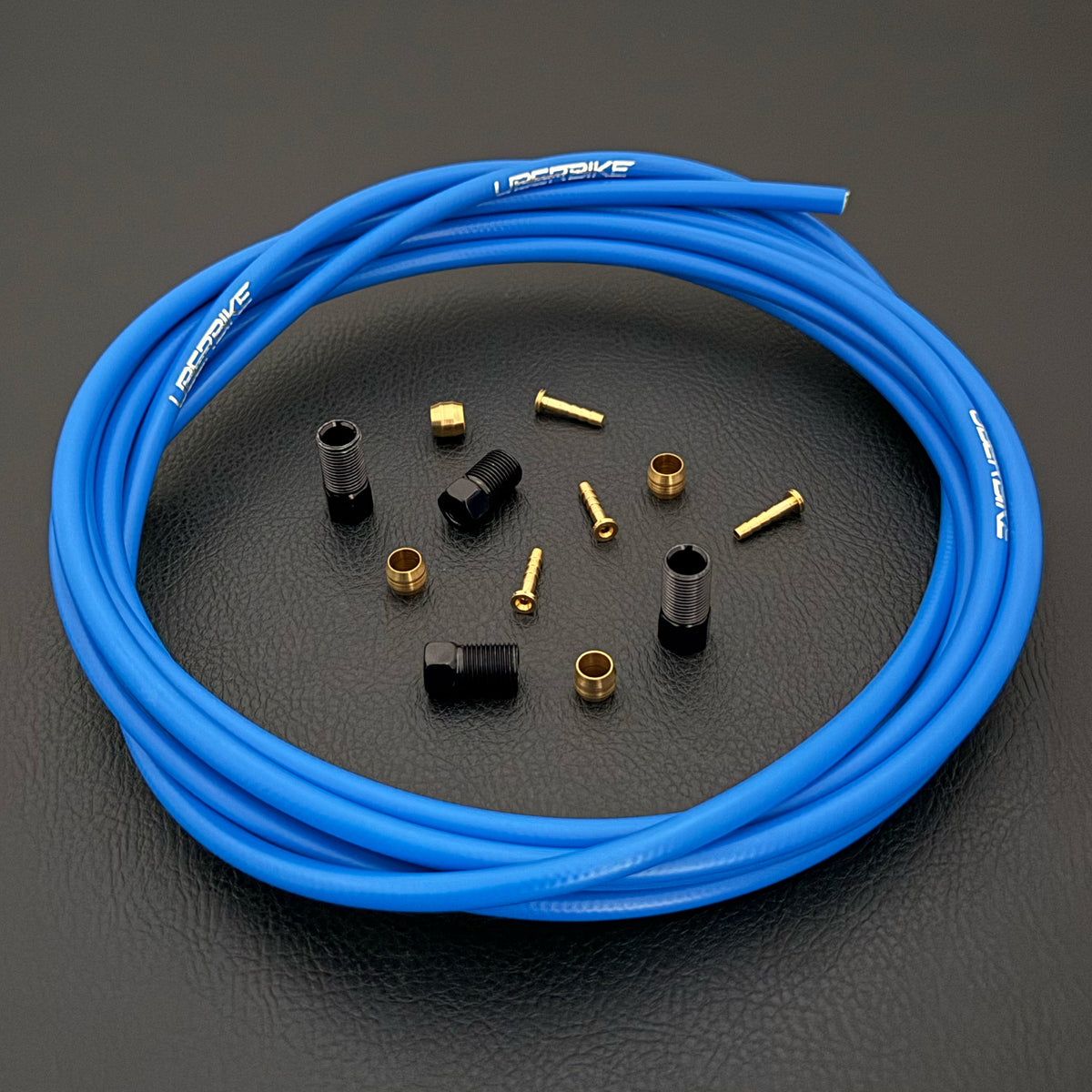 Shimano deore hydraulic blue kevlar brake hose kit with straight connector fittings and Uberbike branding on a black background