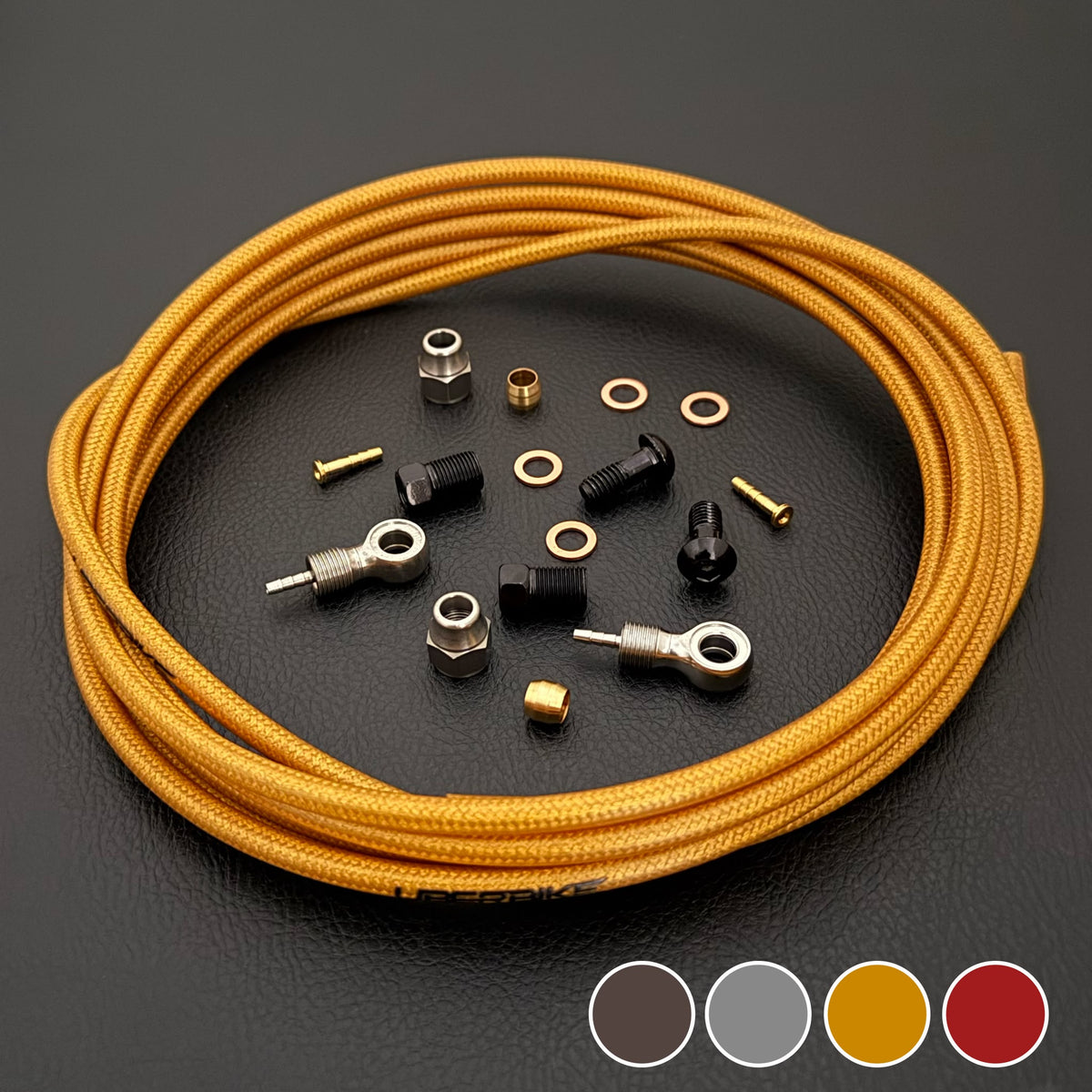 Shimano Deore XT gold Kevlar braid with banjo fittings with Uberbike branding and a colour sample in the bottom right hand corner on a black background