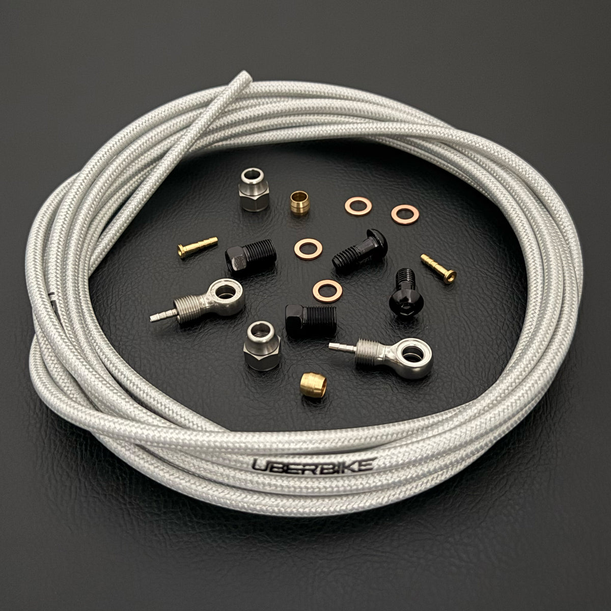 Shimano deore xt hydraulic black kevlar braid brake hose kit with banjo fittings and Uberbike branding on a black background