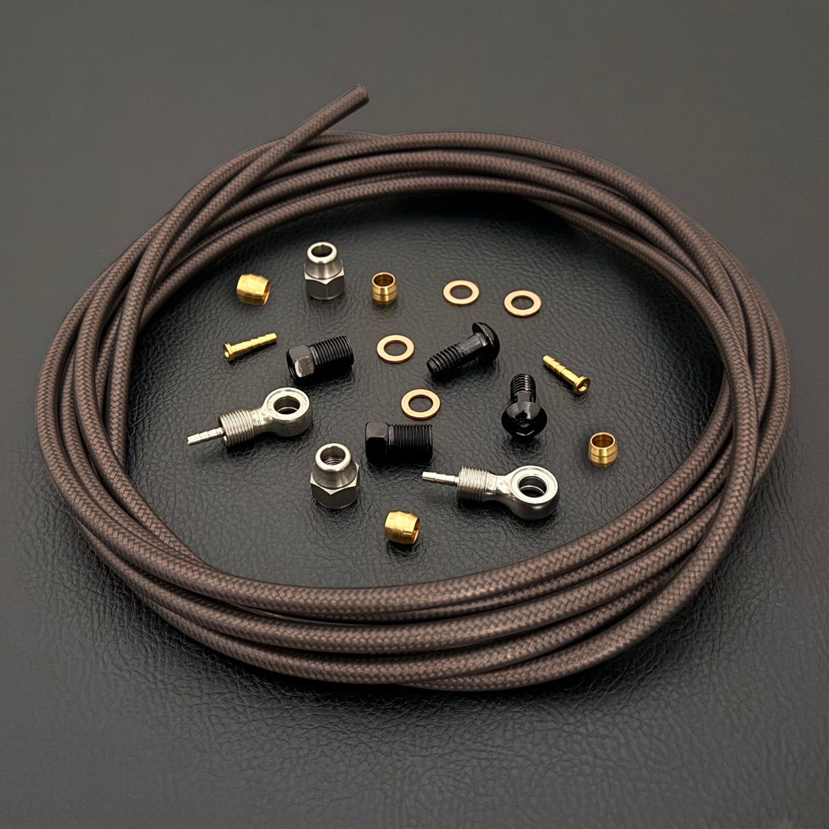 Shimano slx smoke braid kevlar hydraulic brake hose kit with banjo fittings and Uberbike branding on a black background