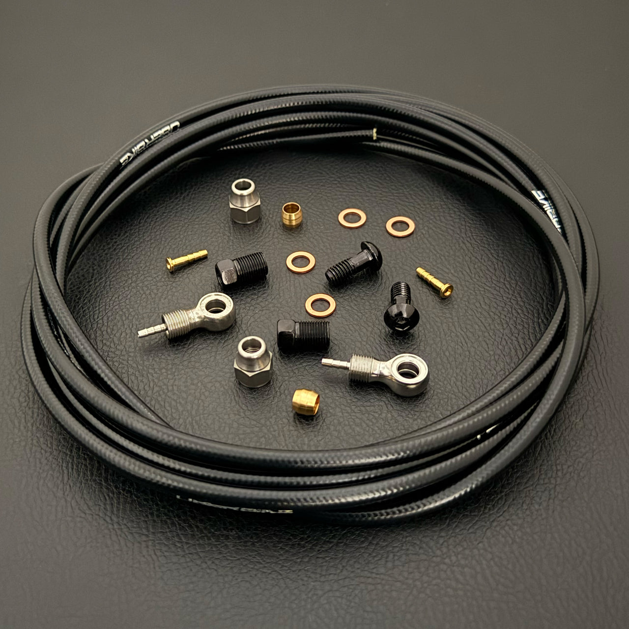 Shimano xtr hydraulic black kevlar brake hose kit with banjo fittings and Uberbike branding on a white background