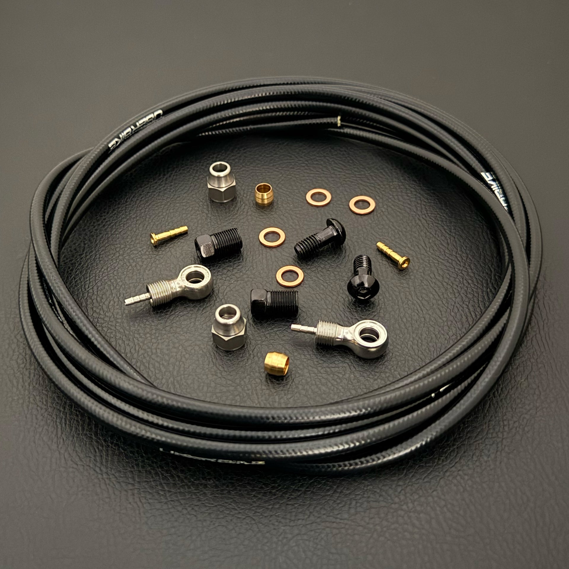 Shimano xtr hydraulic black kevlar brake hose kit with banjo fittings and Uberbike branding on a white background