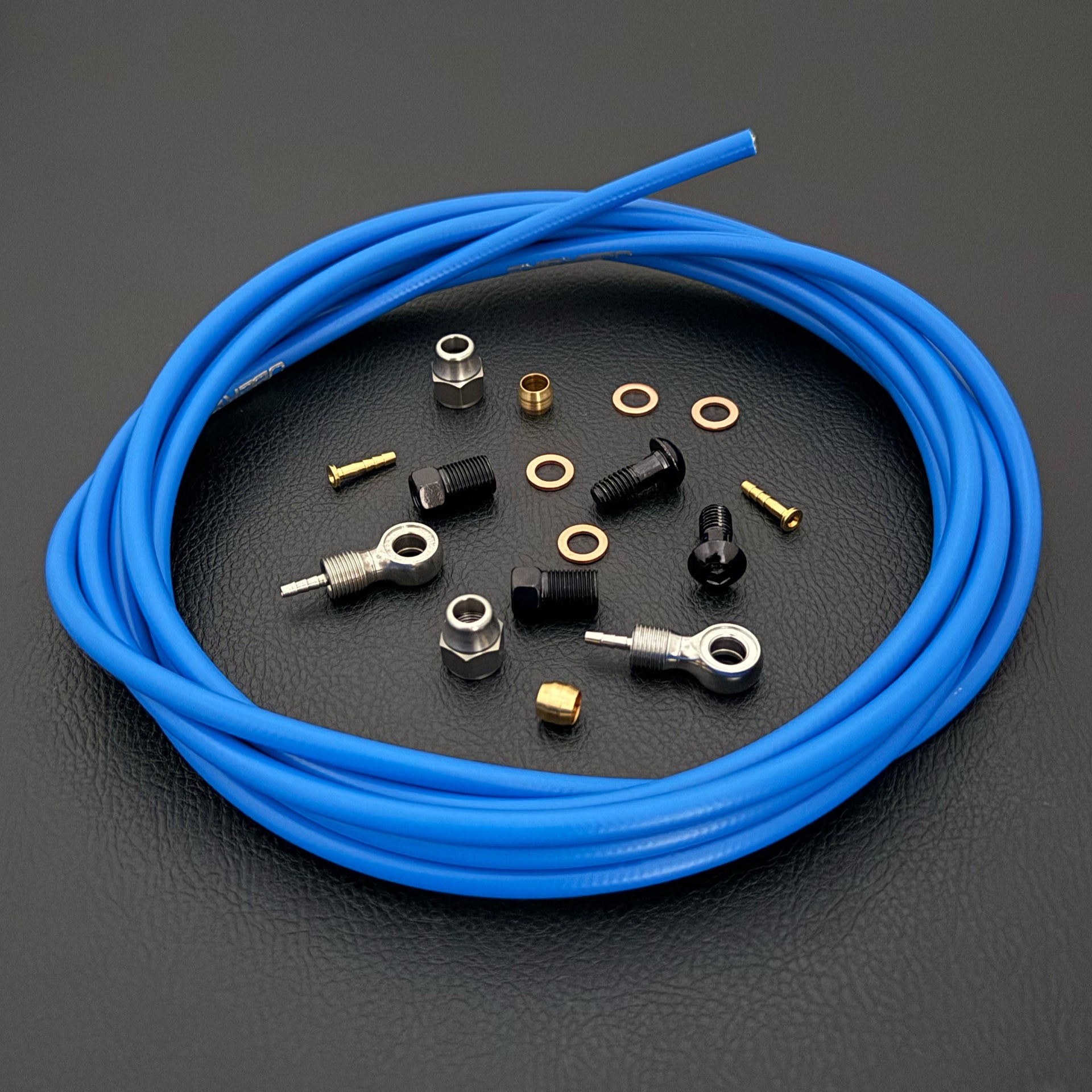 Shimano xtr hydraulic blue kevlar brake hose kit with banjo fittings and Uberbike branding on a white background