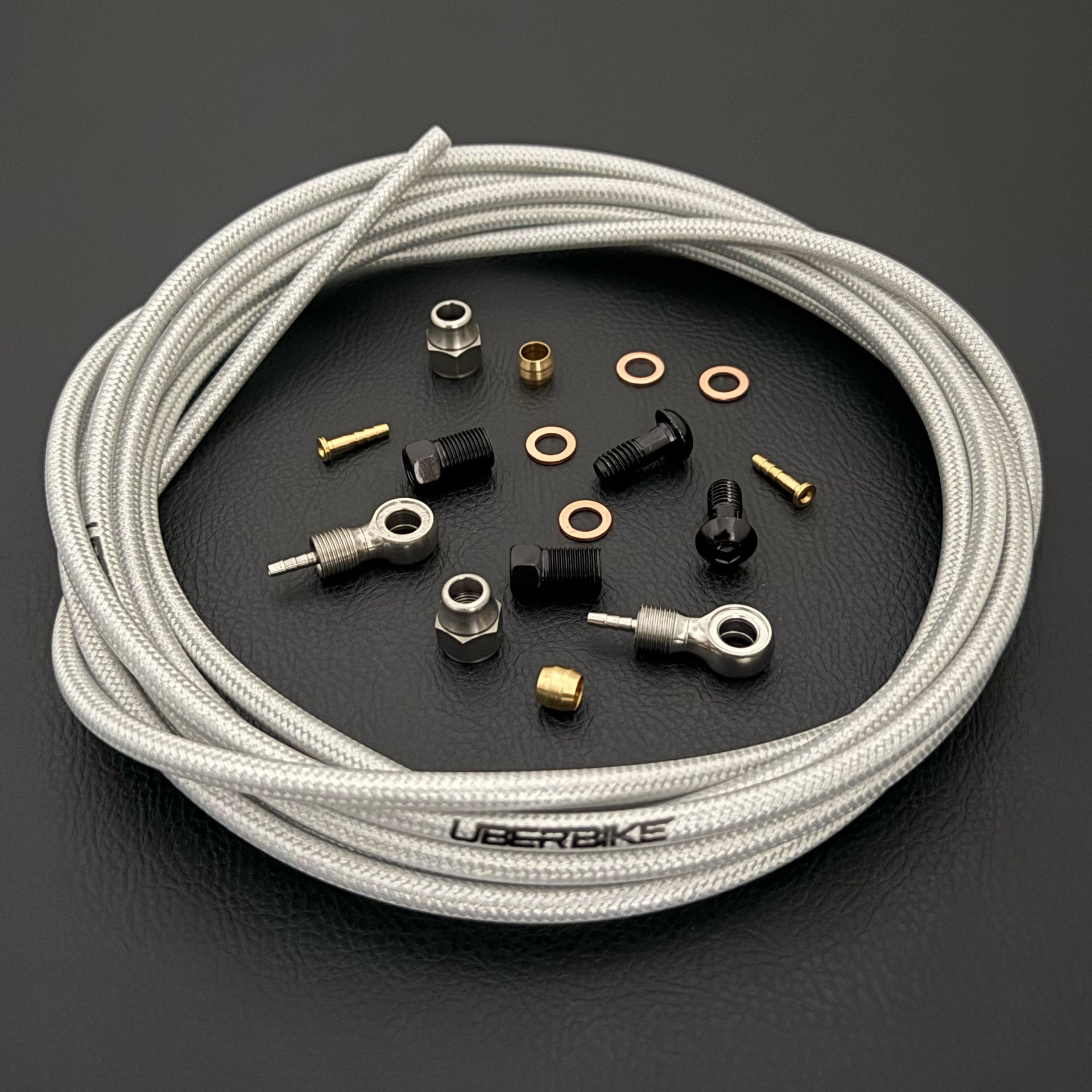 Shimano xtr hydraulic black kevlar braid brake hose kit with banjo fittings and Uberbike branding on a white background