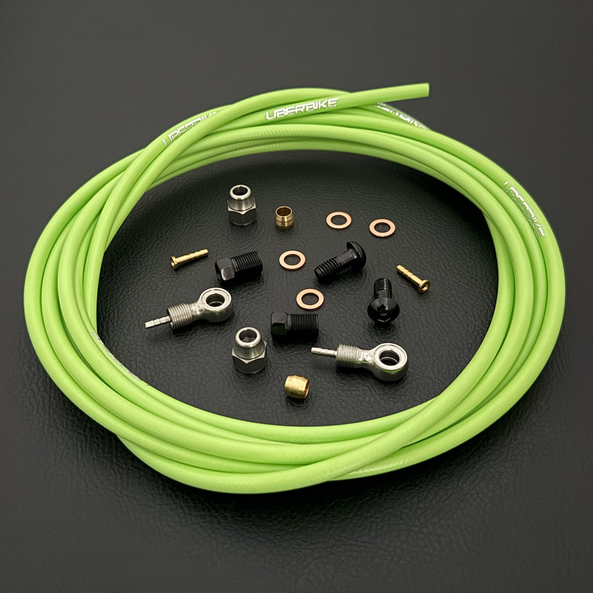 Shimano xtr hydraulic green  kevlar brake hose kit with banjo fittings and Uberbike branding on a white background