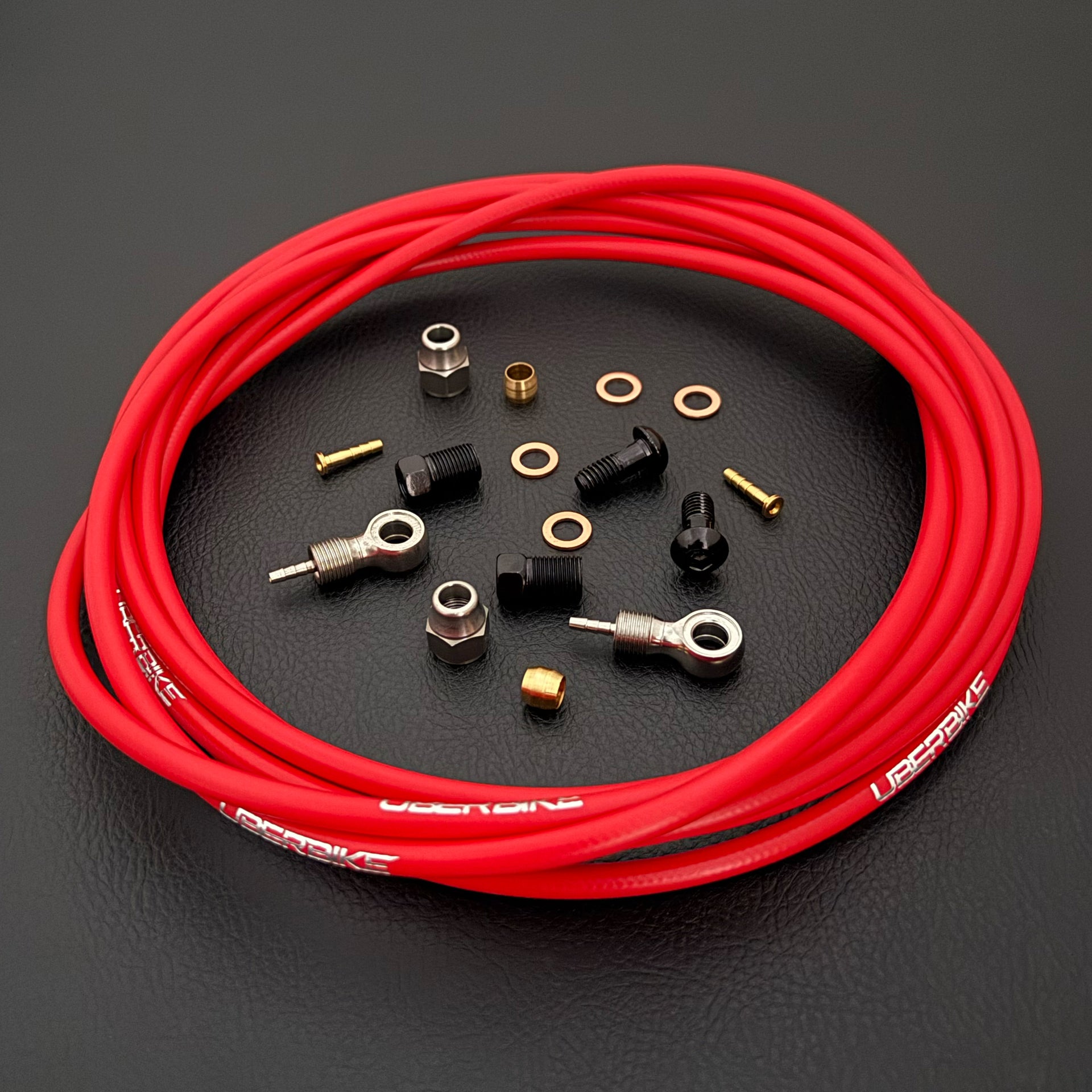Shimano xtr hydraulic black kevlar brake hose kit with banjo fittings and Uberbike branding on a white background