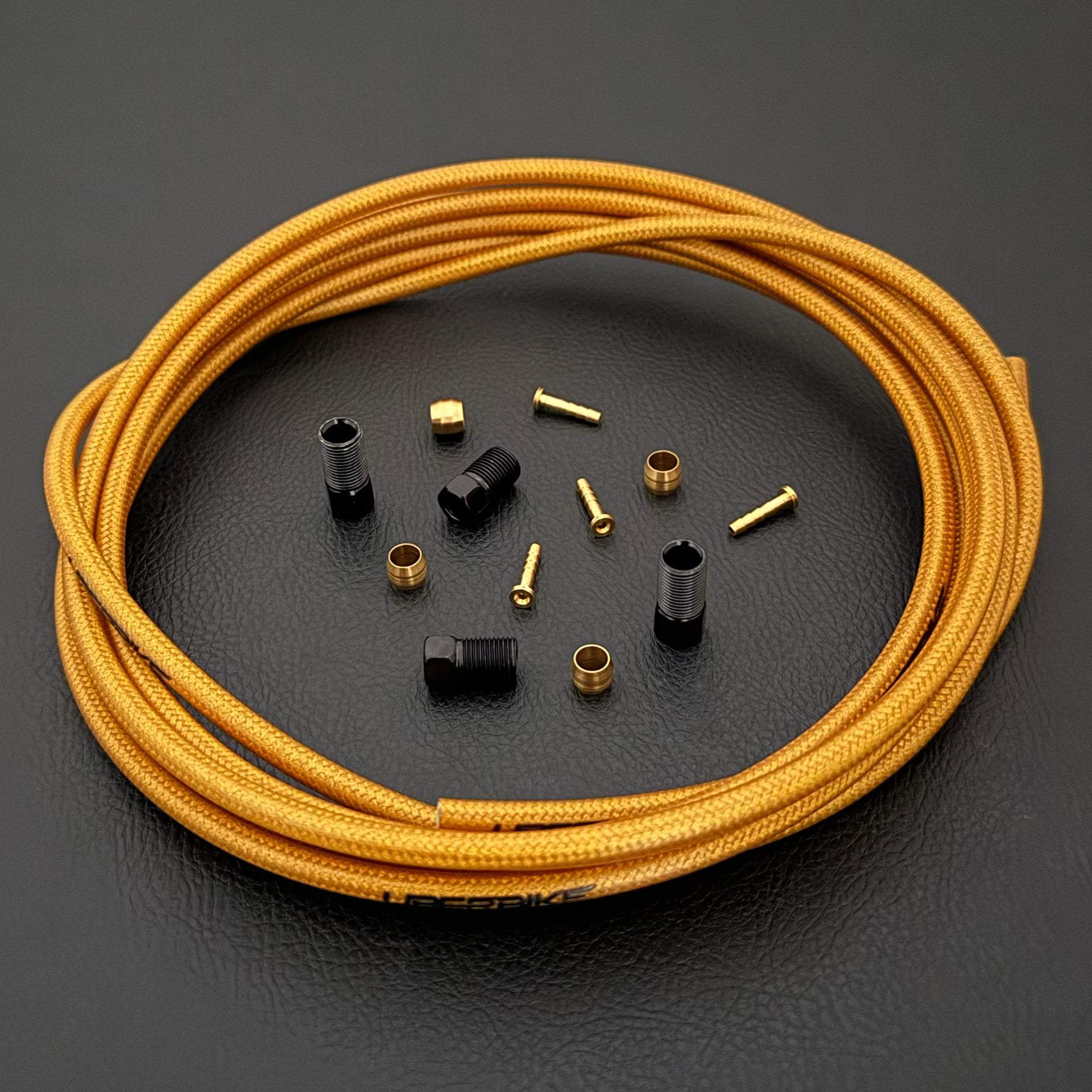 Shimano xtr hydraulic gold kevlar braid brake hose kit with straight connector fittings and Uberbike branding on a white background