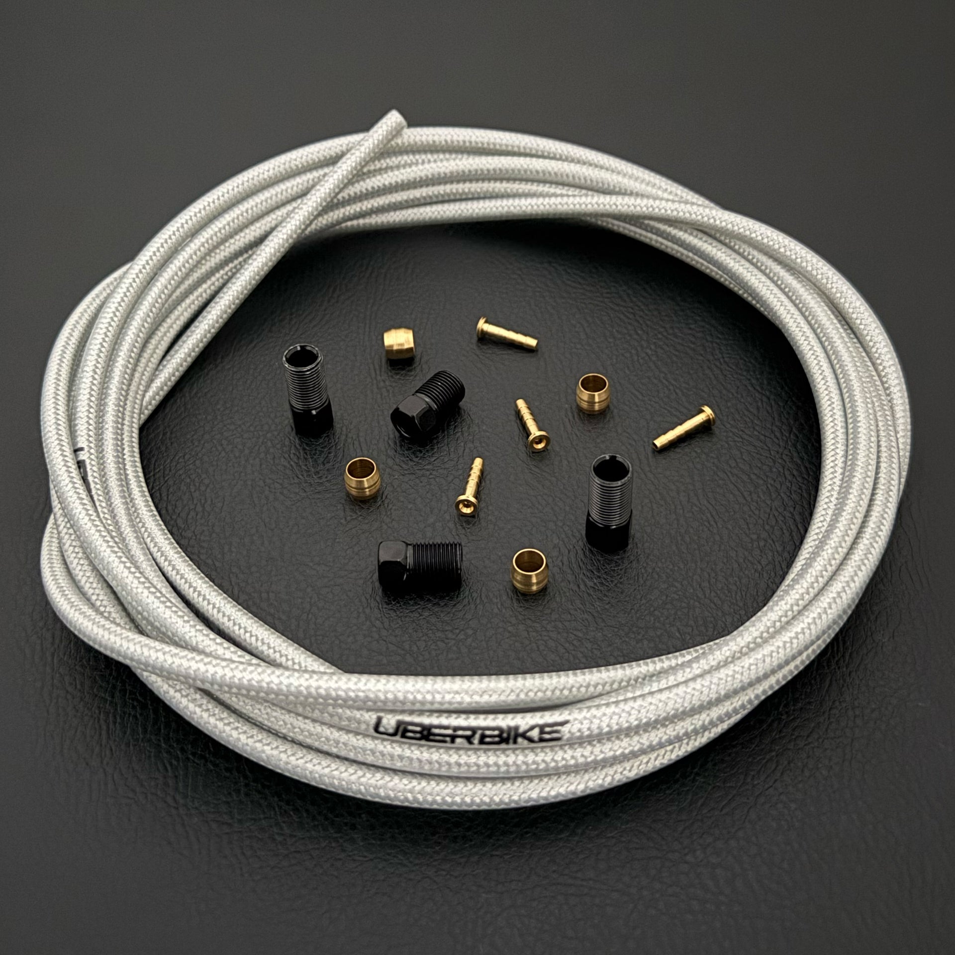 Shimano xtr hydraulic silver braid  kevlar brake hose kit with straight connector fittings and Uberbike branding on a white background