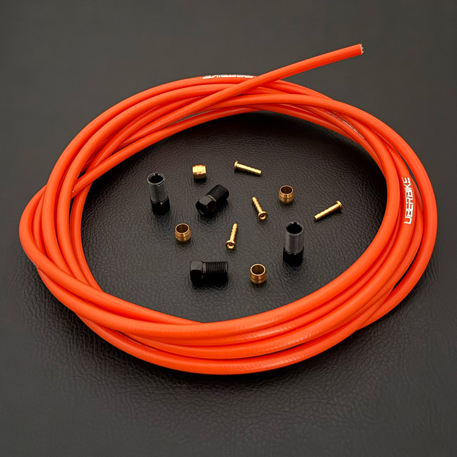 Shimano xtr hydraulic orange kevlar brake hose kit with straight connector fittings and Uberbike branding on a white background