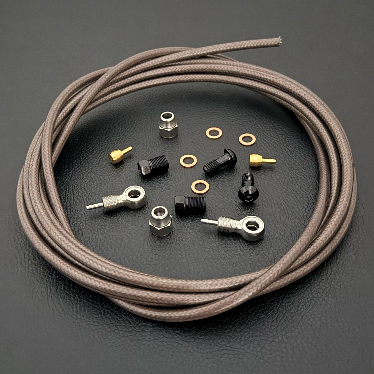 TRP Evo Pro / Evo X hydraulic smoke briad stianless brake hose kit with banjo fittings and Uberbike branding on a black background