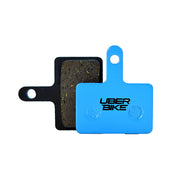 Tektro Auriga brake pads with ematrix compound and Uberbike branding on a white background