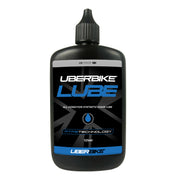 Black bottle of Uberbike chain Lube on a white background