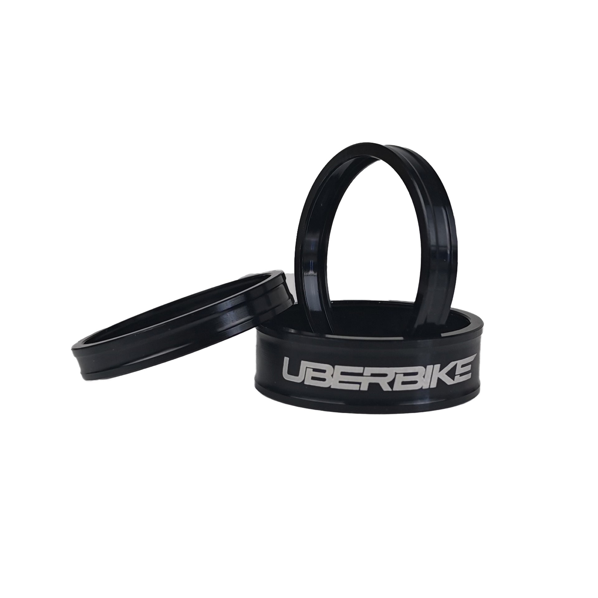 3 black headset spacers with Uberbike branding on a white background