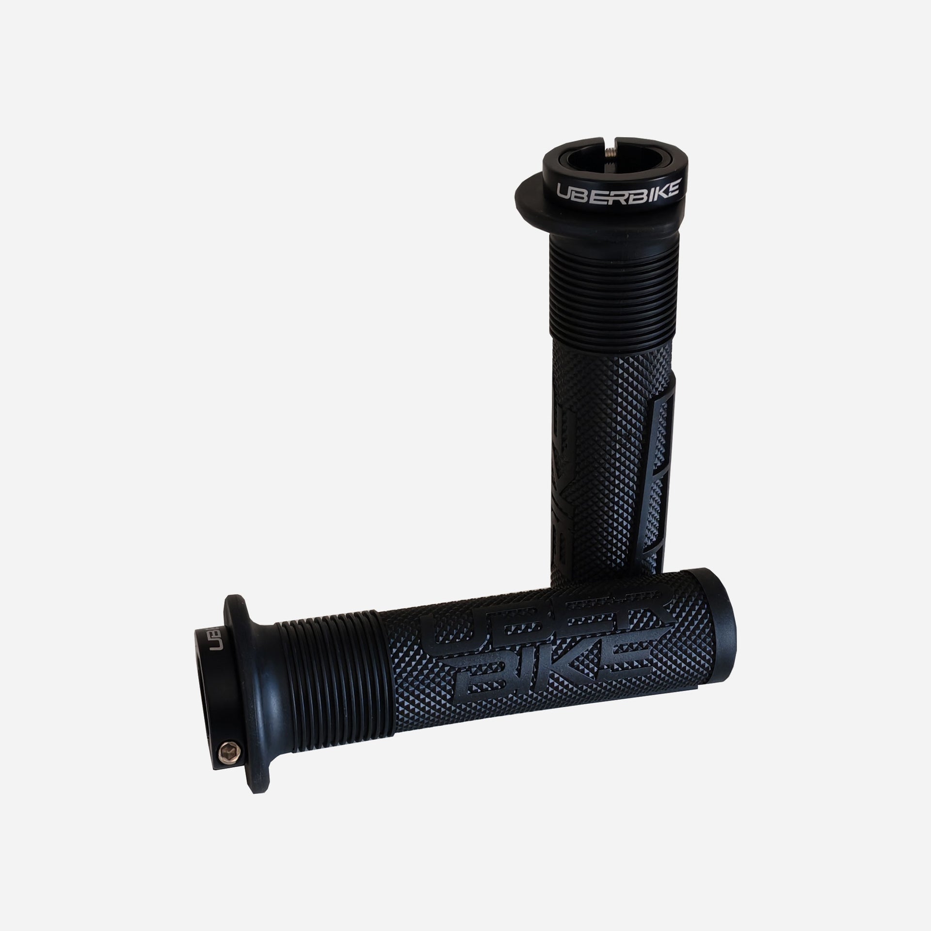 2 blackmushroom mountain bike grips with black lockrings and uberbike branding on a white background