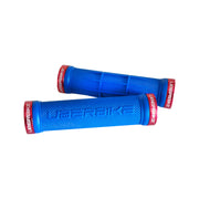 2 blue half waffle mountain bike grips with red lockrings and uberbike branding on a white background