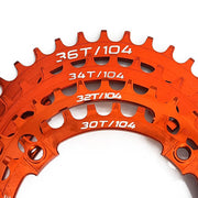 orange bicycle chainring with multiple tooth counts on a white background