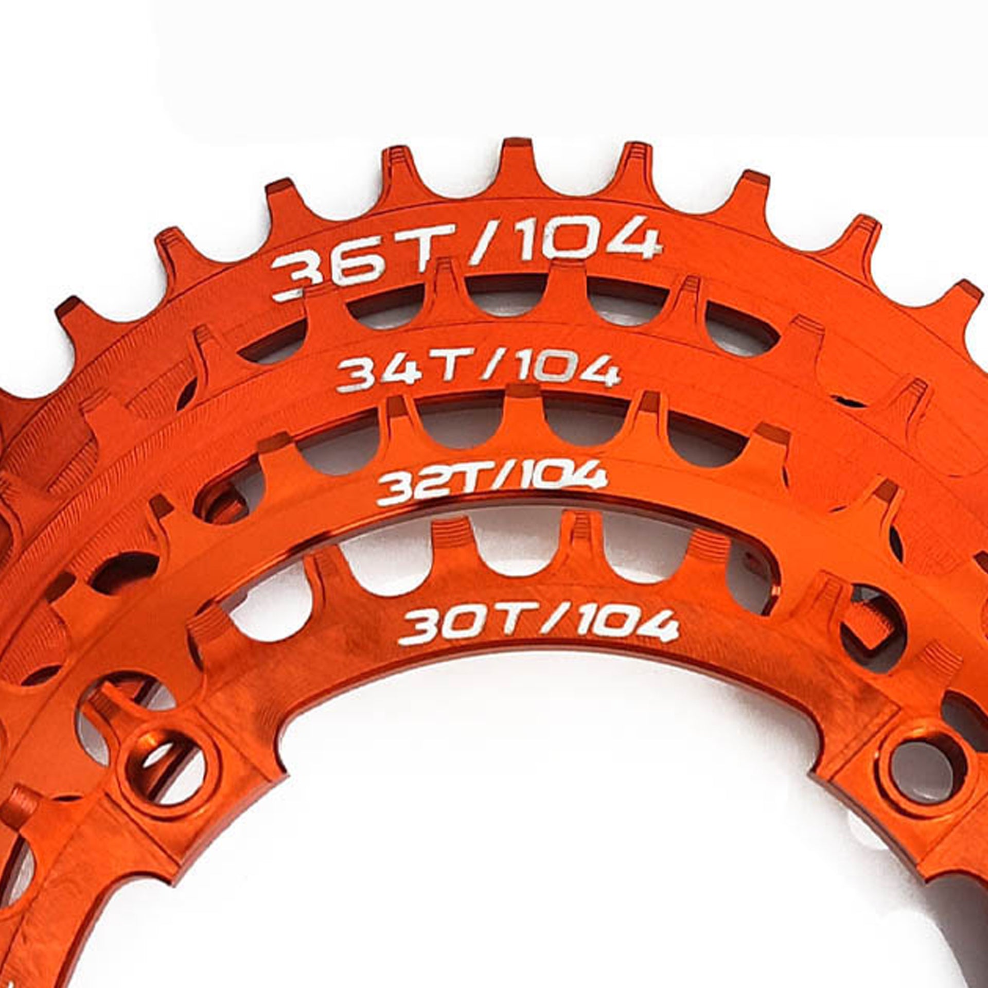 4 orange chainrings in different sizes on a white background