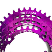 purple bicycle chainring with multiple tooth counts on a white background