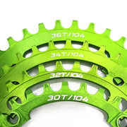 four green chainrings of different sizes on a white background