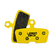 Yellow brake pads with black material, branded 'UberBike', on a white background.