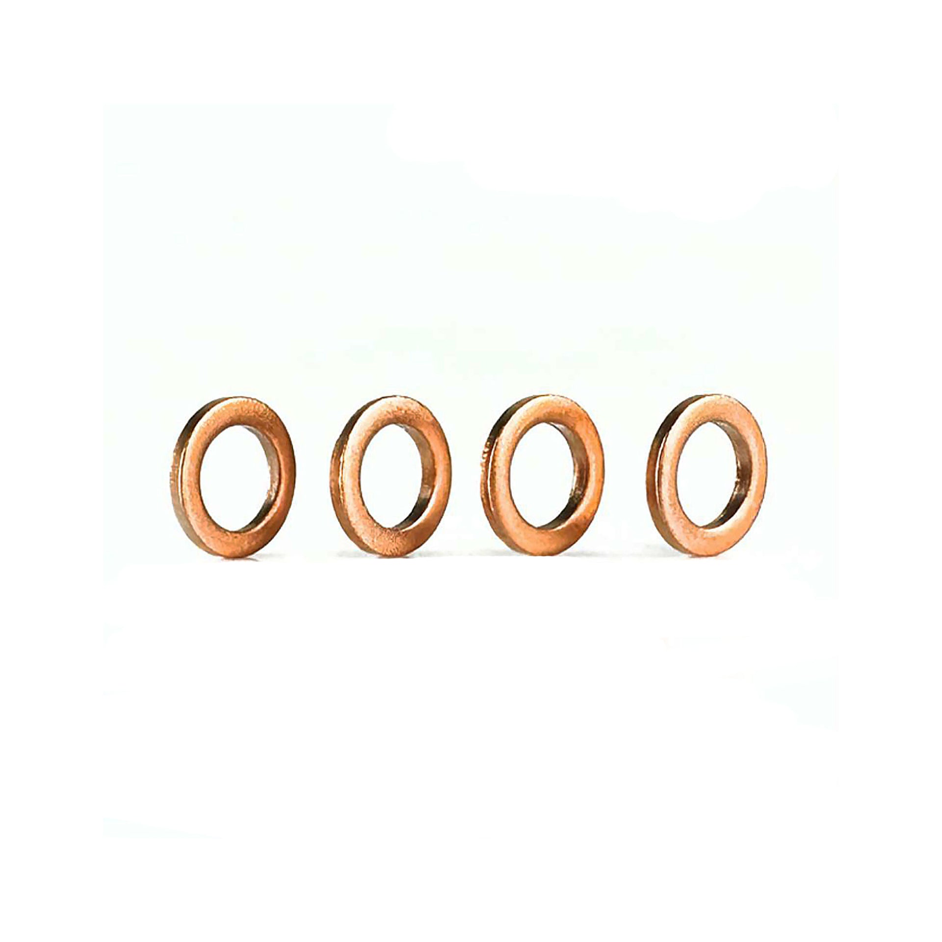 4 copper washers on a white background
