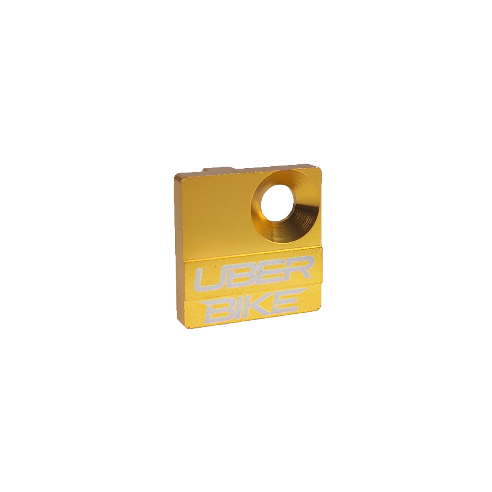 Gold derailleur cover with UberBike branding on a white background