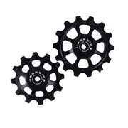 one ceramic black 12 tooth and one 14 tooth jockey wheel on a white background