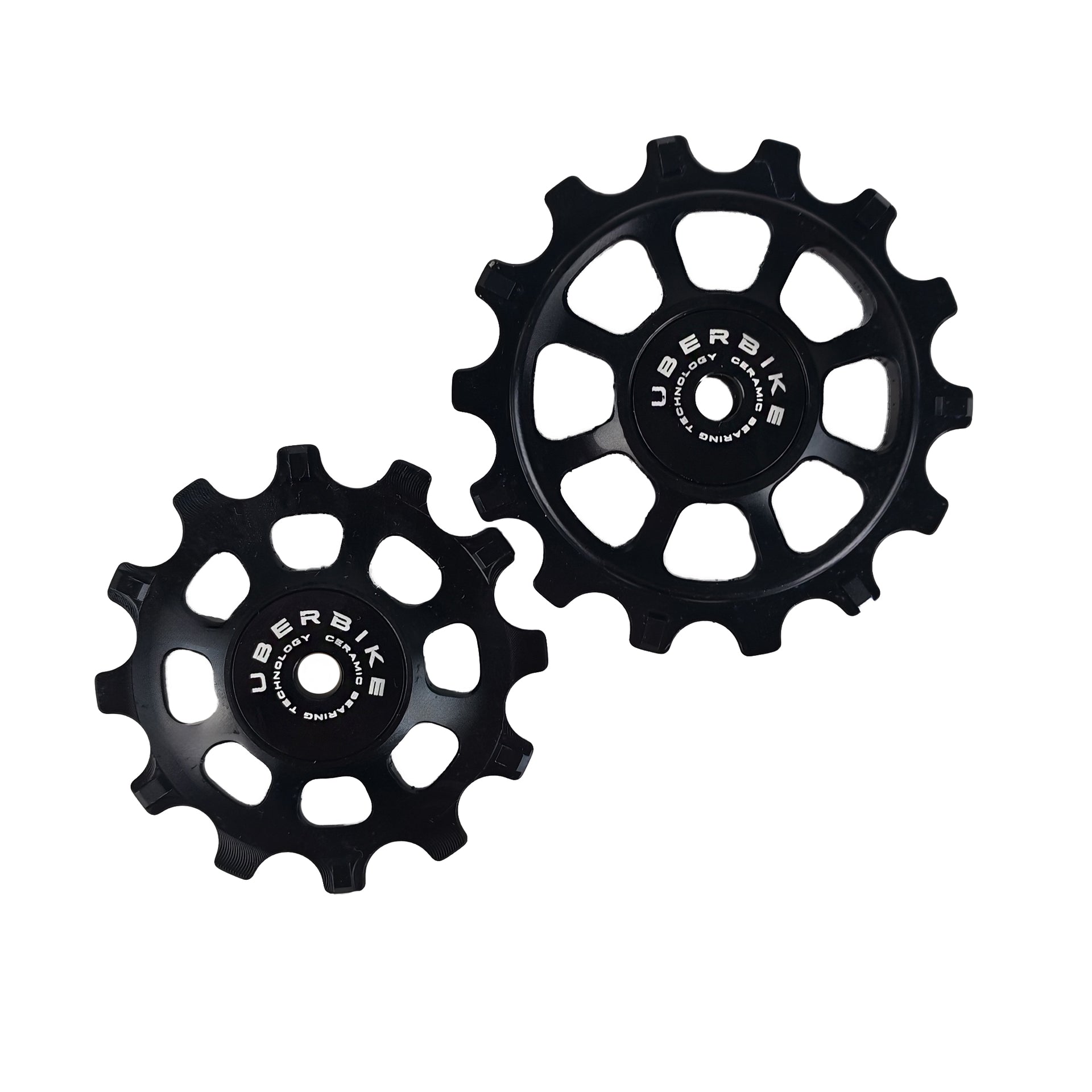 one ceramic black 12 tooth and one 14 tooth jockey wheel on a white background
