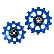 one ceramic blue 12 tooth and one 14 tooth jockey wheel on a white background
