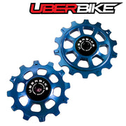 Two blue ceramic pulleys with Uberbike logo on a white background.