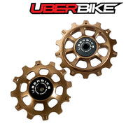Two bronze colour Ceramic pulley wheels with 'Uberbike' branding on a white background.