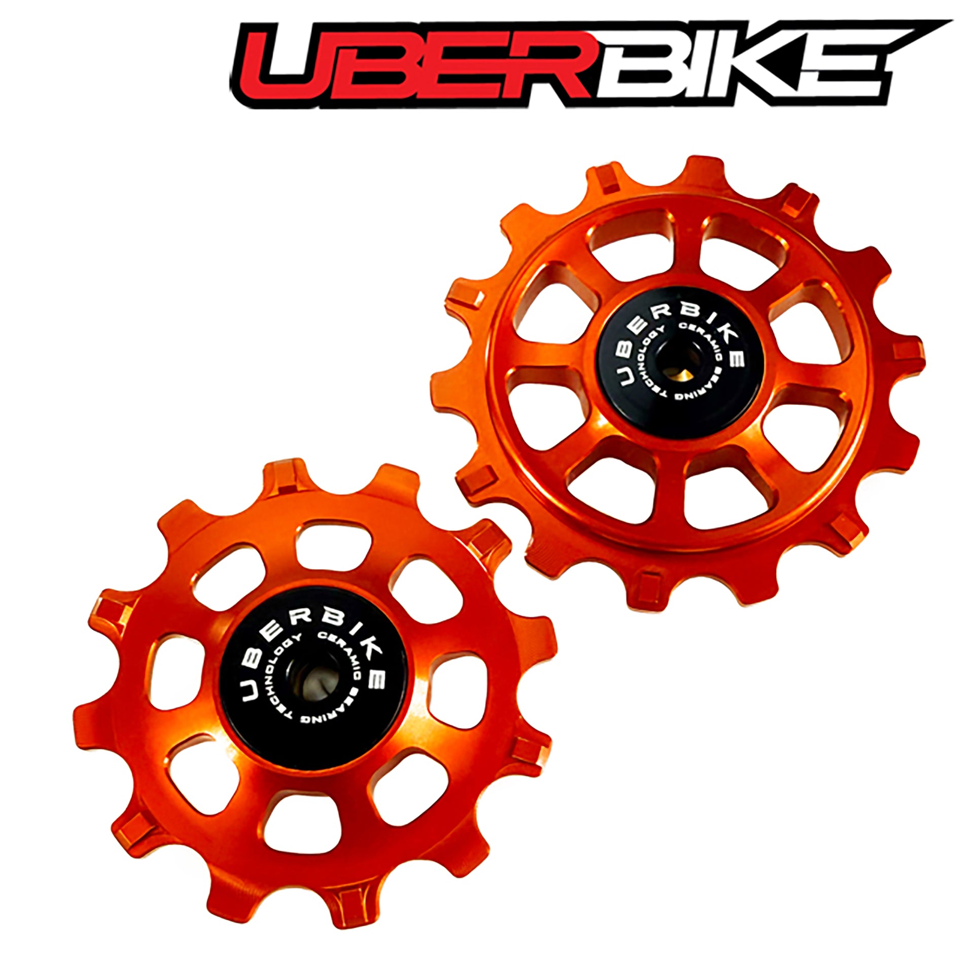 Two orange ceramic pulley wheels with 'Uberbike' branding on a white background.