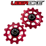 Two red ceramic pulley wheels with 'Uberbike' branding on a white background.