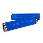 two blue fat grip mountain  bike grips and oil slick lockrings on a white background