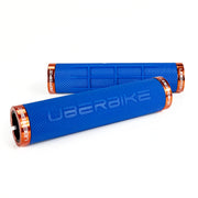 two blue fat grip mountain  bike grips and orange lockrings on a white background