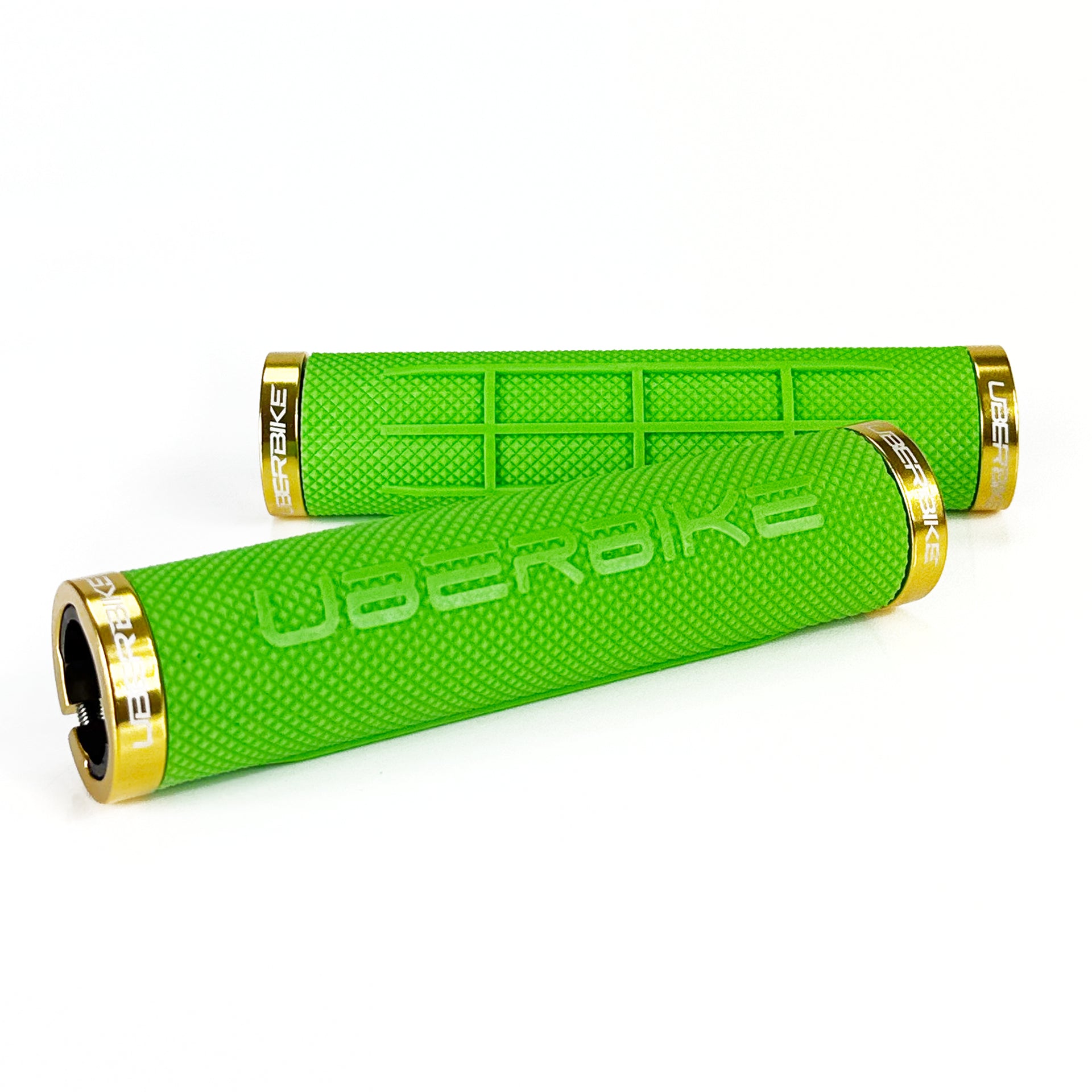 two green fat grip mountain  bike grips and gold lockrings on a white background