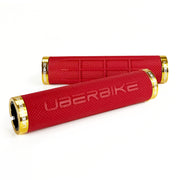 two red fat grip mountain  bike grips and gold lockrings on a white background