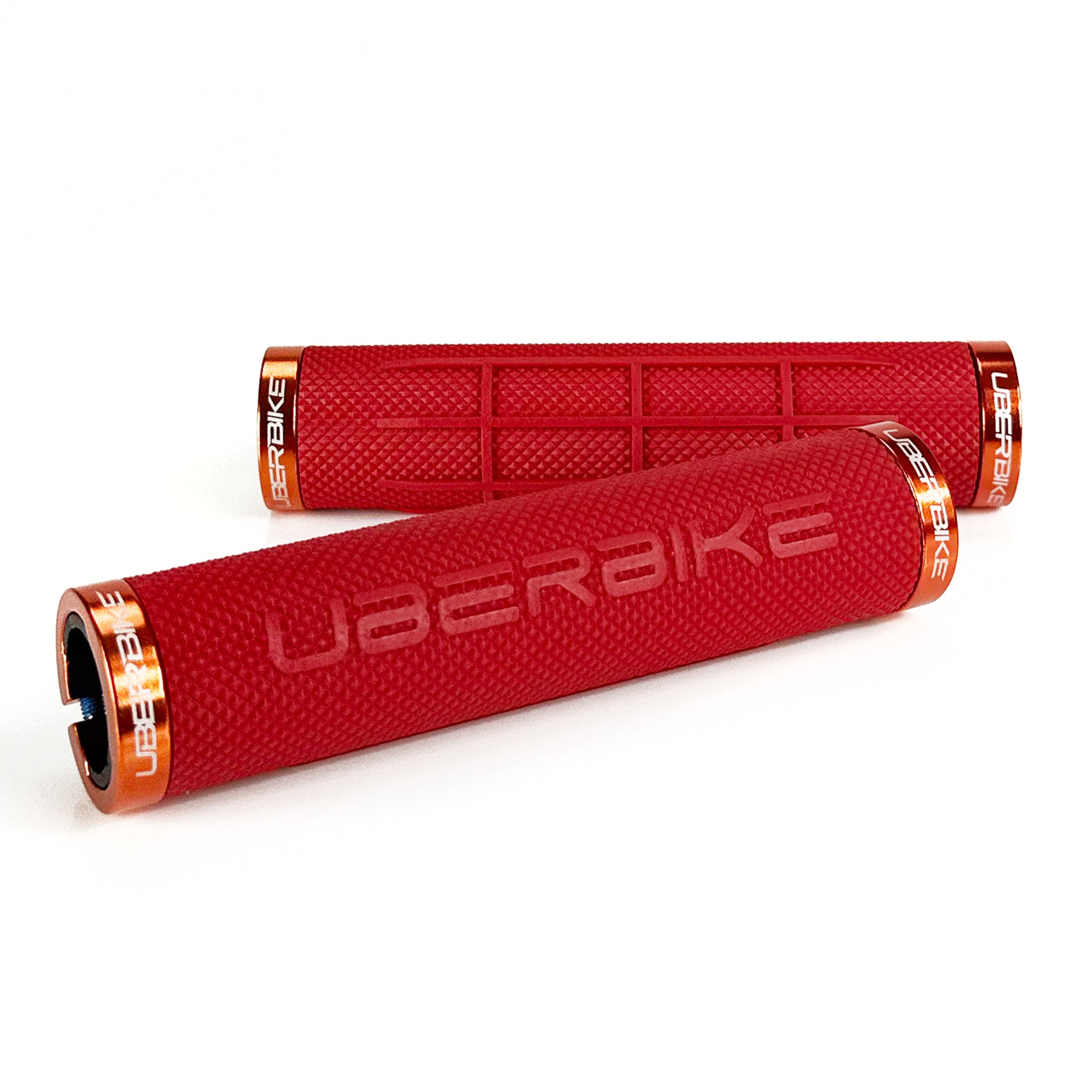 two red fat grip mountain  bike grips and orange lockrings on a white background